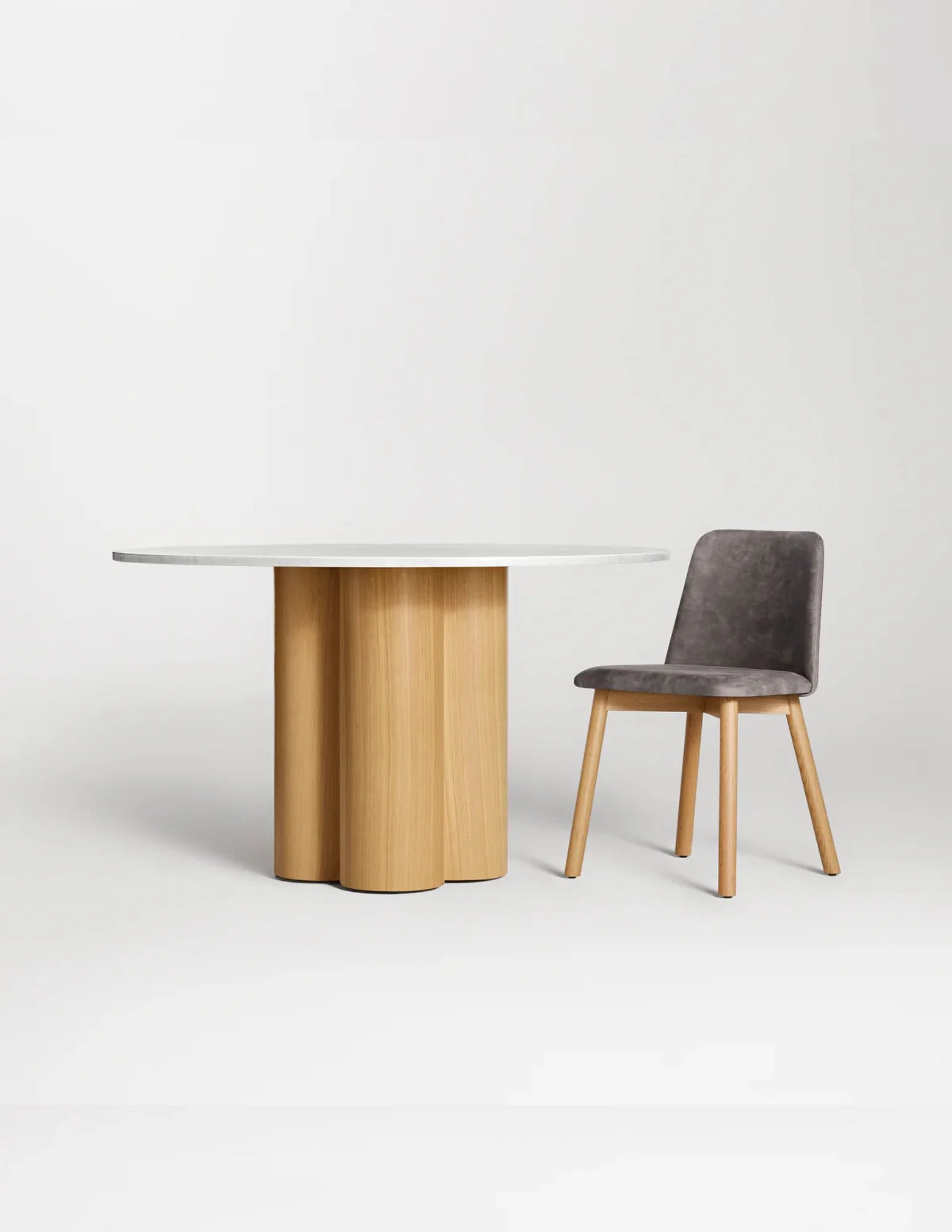 Marble top round dining table with white oak base and chair