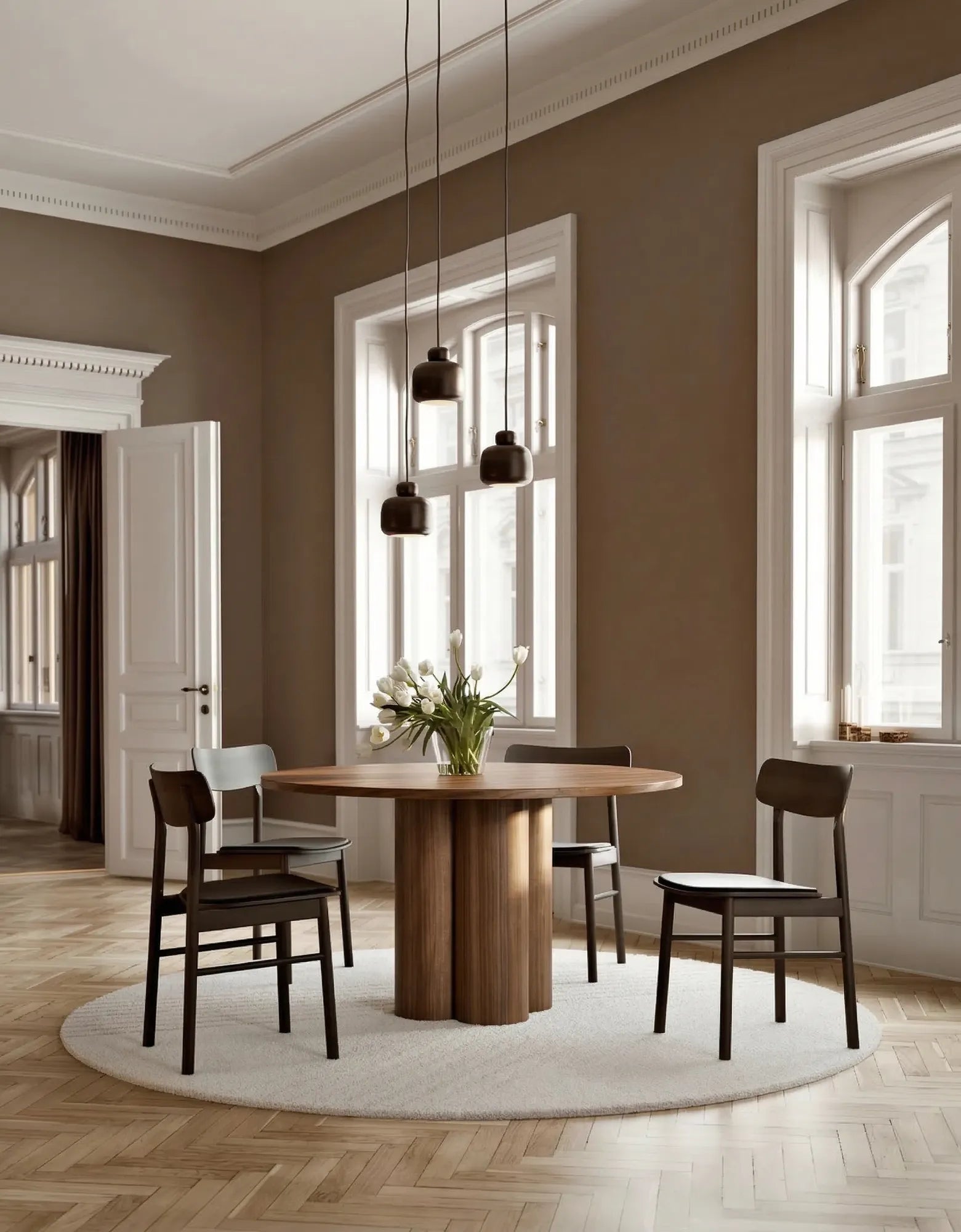 Walnut round wooden dining table styled in modern dining space